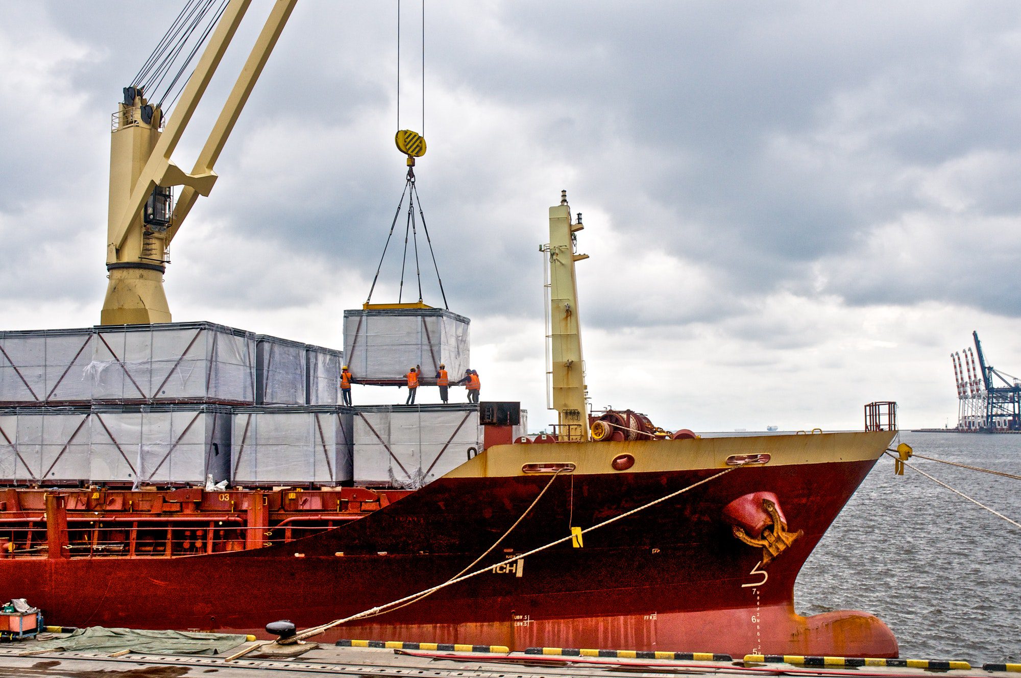 Loading cargo into the ship in harbor